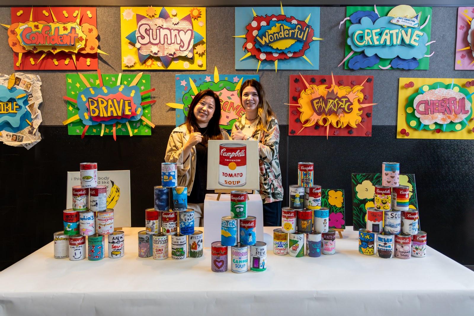 Students' Andy Warhol inspired soup cans and pop-art word panels on show from Reach to Teach: Immersed in the Arts.